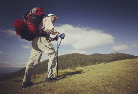 Man tourist walking the mountains with a backpack.の写真素材