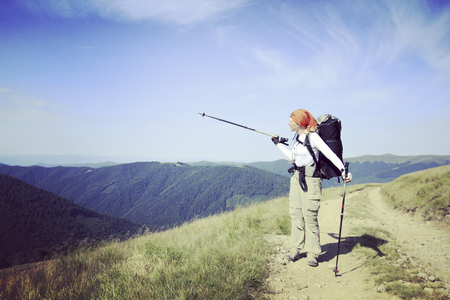 Man tourist walking the mountains with a backpack.の写真素材