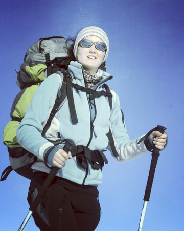 Winter hiking in the mountains on snowshoes with a backpack and tent.