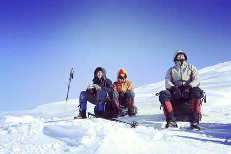 Winter hiking in the mountains on snowshoes with a backpack and tent.の写真素材