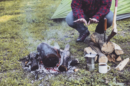 Cooking breakfast on a campfire at a summer camp.の写真素材