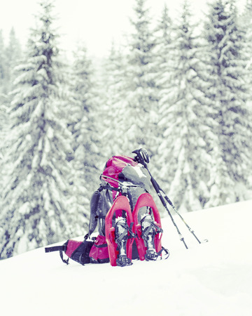 Winter hiking in the mountains on snowshoes with a backpack and tent.の写真素材