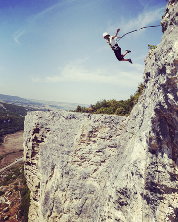 Jump off a cliff into a canyon with a rope.