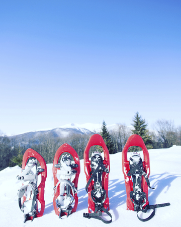 Winter hiking in the mountains on snowshoes with a backpack and tent.の写真素材