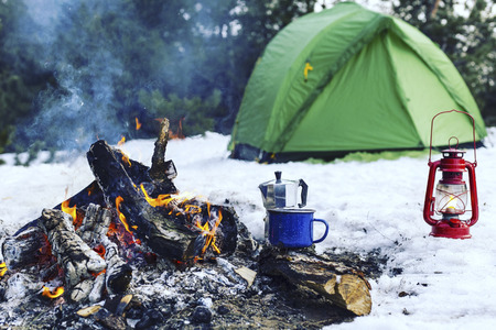 Cooking breakfast on a fire in a tent camp.の写真素材