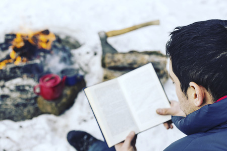 Cooking breakfast on a fire in a tent camp.の写真素材