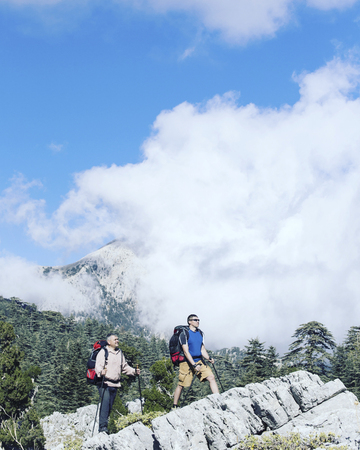 Summer hiking in the mountains with a backpack and tent.の写真素材