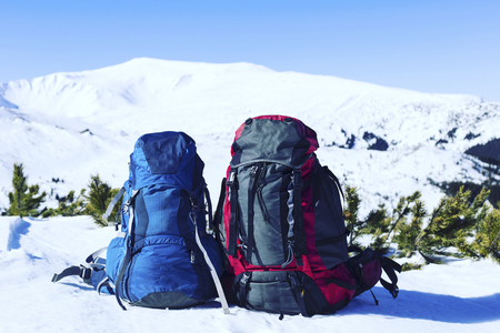 Winter hiking in the mountains on snowshoes with a backpack and tent.の写真素材