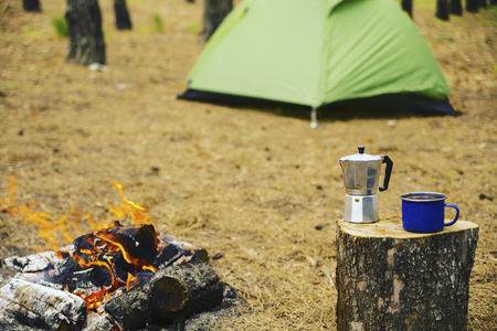Camping in the forest. Preparation of breakfast at the stake.の写真素材