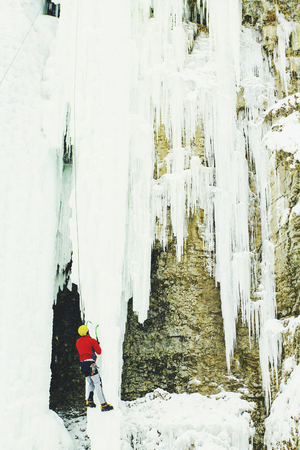 Ice climbing in the northern Caucasus. A man climbs the waterfall.の写真素材