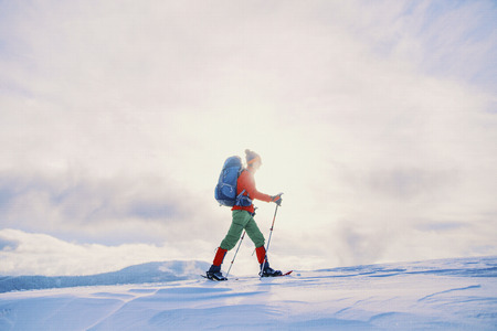 Winter hike in the mountains with a backpack and tent.の写真素材