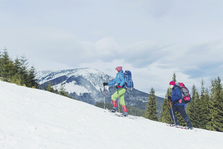 Winter hiking in the mountains on snowshoes with a backpack and tent.の写真素材
