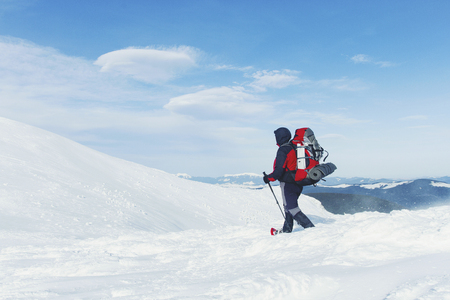Snowshoe walker running in powder snow with beautiful sunrise light. Outdoor winter activity and healthy lifestyleの写真素材