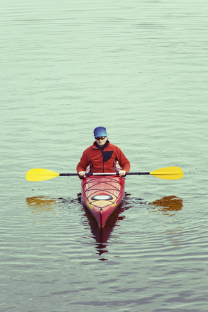 A man rafts down the river on a kayak.の写真素材