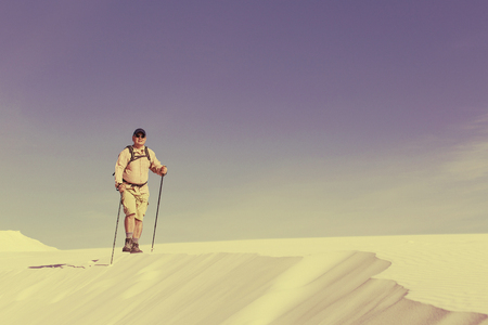 Journey through the desert with a backpack and tent. The tent is on a sandy crest.の写真素材