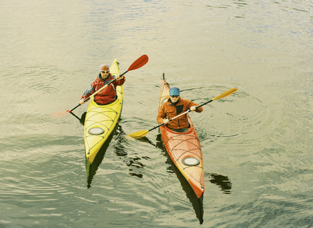 Two men are kayaking along the river.の写真素材