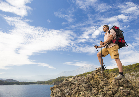 Summer hike in the mountains with a backpack and tent.の写真素材