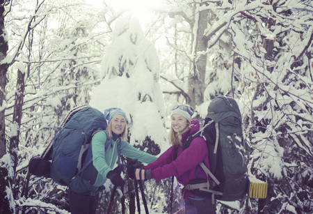 Two girls are walking in the winter forest.の写真素材