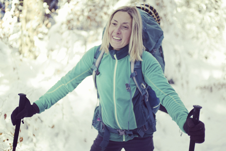 The girl walks in the winter forest.の写真素材