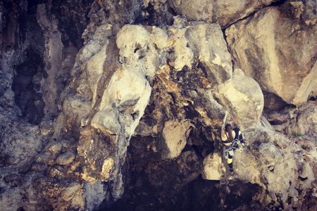 Girl rock climber climbs difficult route on the cliffs.の写真素材