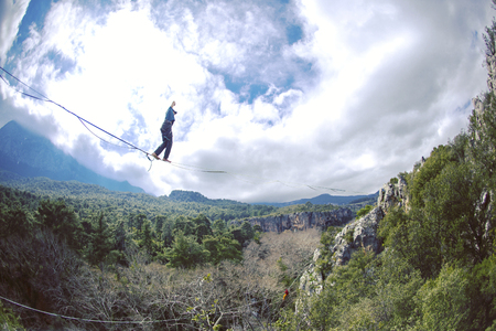 Man balancing on the rope concept of risk taking and challenge.の写真素材