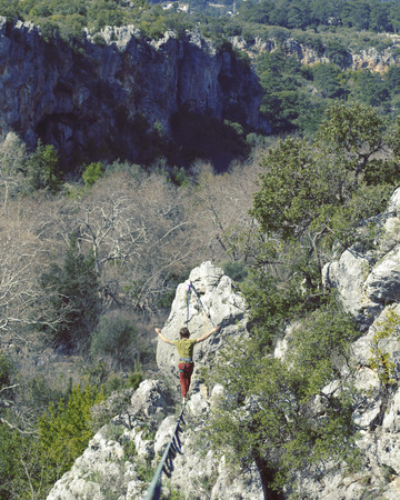 Man balancing on the rope concept of risk taking and challenge.