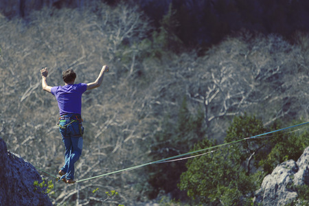 Man balancing on the rope concept of risk taking and challenge.