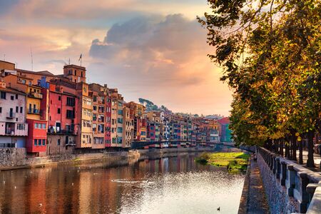 View of the Spanish city of Girona. Old Town, Sunset sky,
colorful houses and the Onyar river.