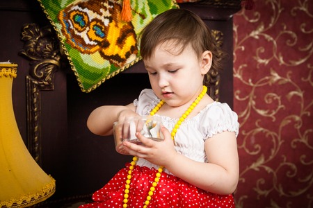 The Girl playing by the fireplace with a threadの写真素材