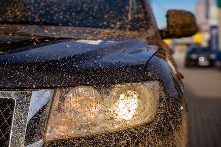 dirty black SUV Headlight close-up, focus on the spotlightの写真素材