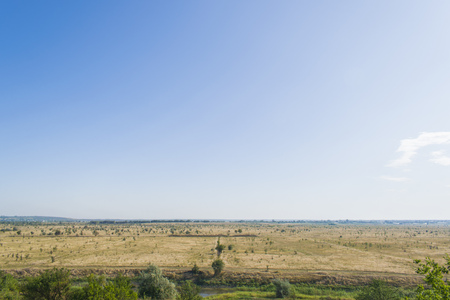 The blue sky on a huge field, all witheredの写真素材