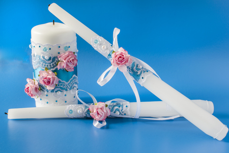 wedding candles decorated on a blue backgroundの写真素材