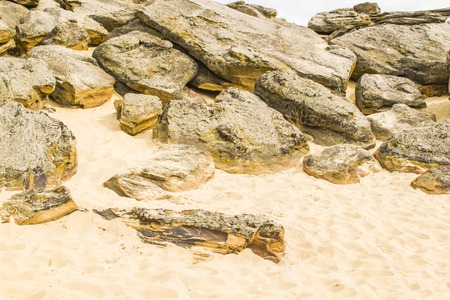 A lot of stones and yellow sand in the stone graves. Many caves under the stonesの写真素材