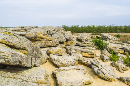 Rocky terrain in abandoned places. Blue clouds. Place of strengthの写真素材
