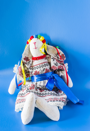 The doll is a guard in a national costume with ribbons. On a blue backgroundの写真素材