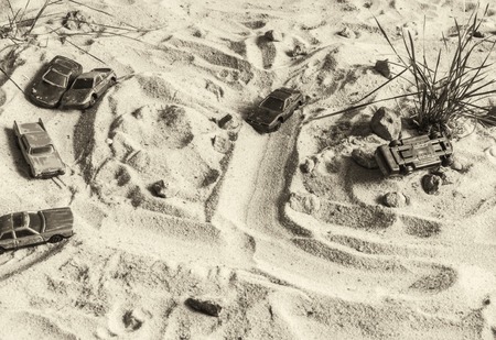 Racing cars on the sand compete in the game. Machines are trying to outrun each other. Black and...