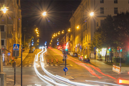 asphalt road in downtown with illuminated modern cityscape and buildings at night.の写真素材