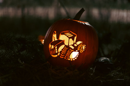 Spooky Halloween photo with carved pumpkins glowing in the dark. Festive autumn atmosphere with candle light, orange pumpkins, and seasonal decorations - perfect for holiday, Halloween, and fall themes.の写真素材