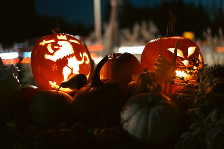 Spooky Halloween photo with carved pumpkins glowing in the dark. Festive autumn atmosphere with...