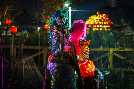 Creepy Halloween photo of a skeleton decoration with spooky lighting and dark background. Perfect for horror, Halloween, and scary holiday themes.の写真素材