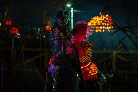 Creepy Halloween photo of a skeleton decoration with spooky lighting and dark background. Perfect for horror, Halloween, and scary holiday themes.の写真素材