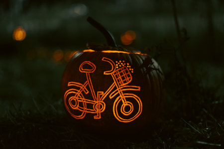 Spooky Halloween photo with carved pumpkins glowing in the dark. Festive autumn atmosphere with candle light, orange pumpkins, and seasonal decorations - perfect for holiday, Halloween, and fall themes.の写真素材