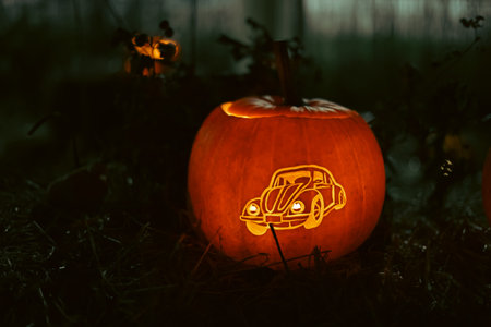 Spooky Halloween photo with carved pumpkins glowing in the dark. Festive autumn atmosphere with candle light, orange pumpkins, and seasonal decorations - perfect for holiday, Halloween, and fall themes.の写真素材