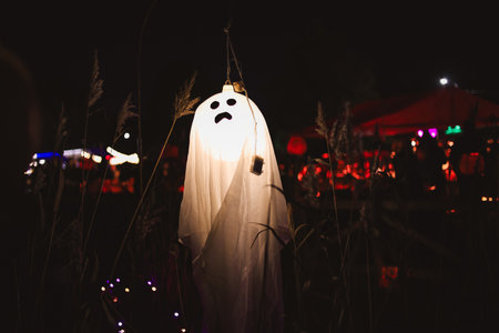 Spooky Halloween photo of a ghost figure in the dark with eerie lighting and misty atmosphere....