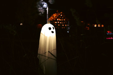 Spooky Halloween photo of a ghost figure in the dark with eerie lighting and misty atmosphere. Perfect for horror, Halloween, and supernatural themes.の写真素材