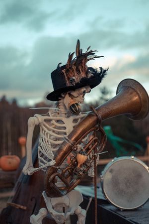 Halloween. Spooky Halloween skeleton with skull and bones in dark background, creepy horror decoration glowing in eerie light for Halloween night.の写真素材