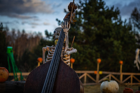 Halloween skeleton with skull and bones in dark background, creepy horror decoration glowing in eerie light for Halloween night.の写真素材
