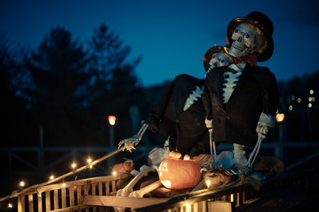 Halloween. Spooky Halloween skeleton with skull and bones in dark background, creepy horror decoration glowing in eerie light for Halloween night.の写真素材