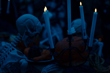 Halloween. Spooky Halloween skeleton with skull and bones in dark background, creepy horror decoration glowing in eerie light for Halloween night.の写真素材