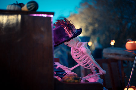 Halloween. Spooky Halloween skeleton with skull and bones in dark background, creepy horror decoration glowing in eerie light for Halloween night.の写真素材